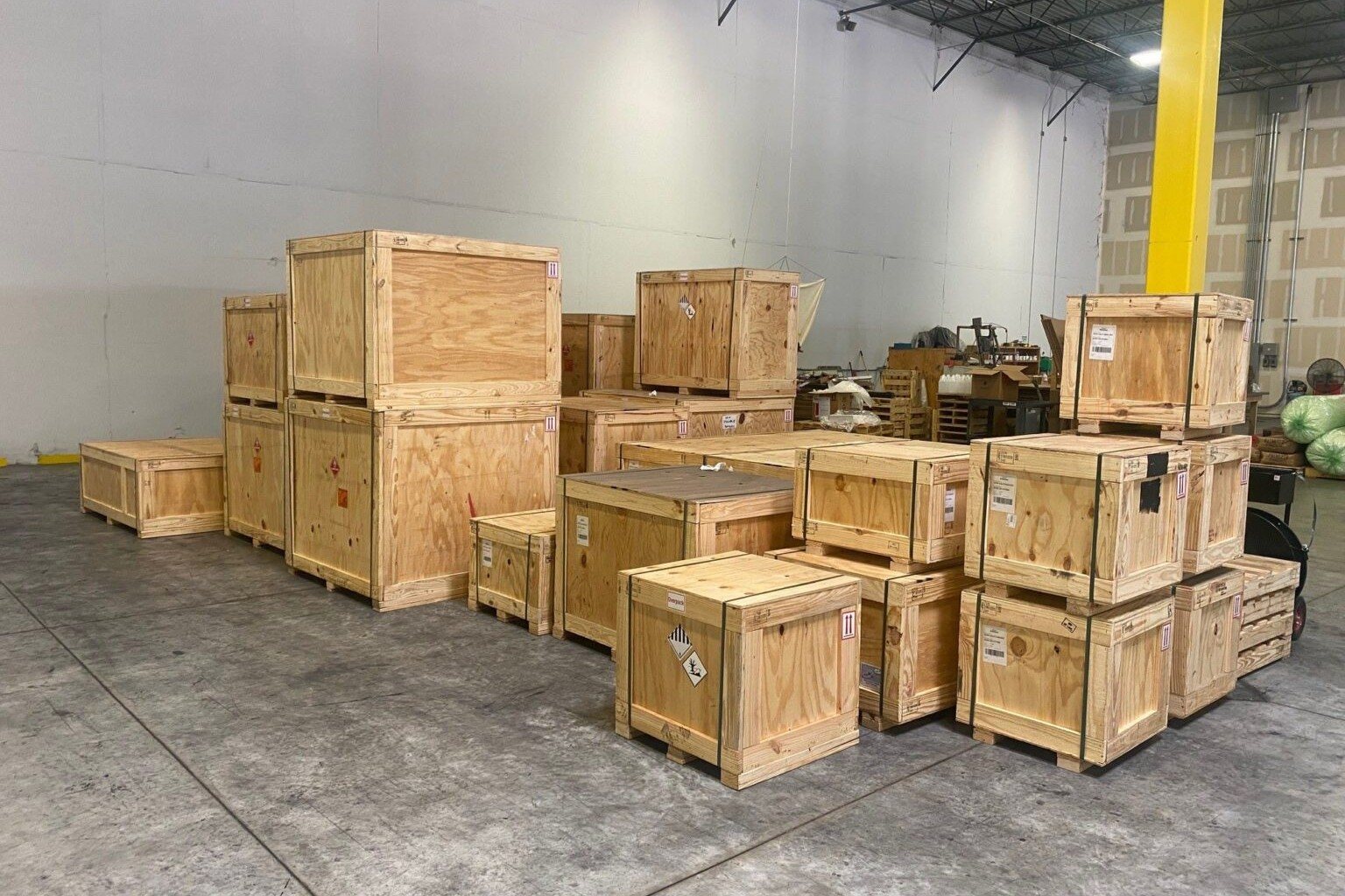 Wooden trophy crates stacked and labelled in a warehouse, ready for export