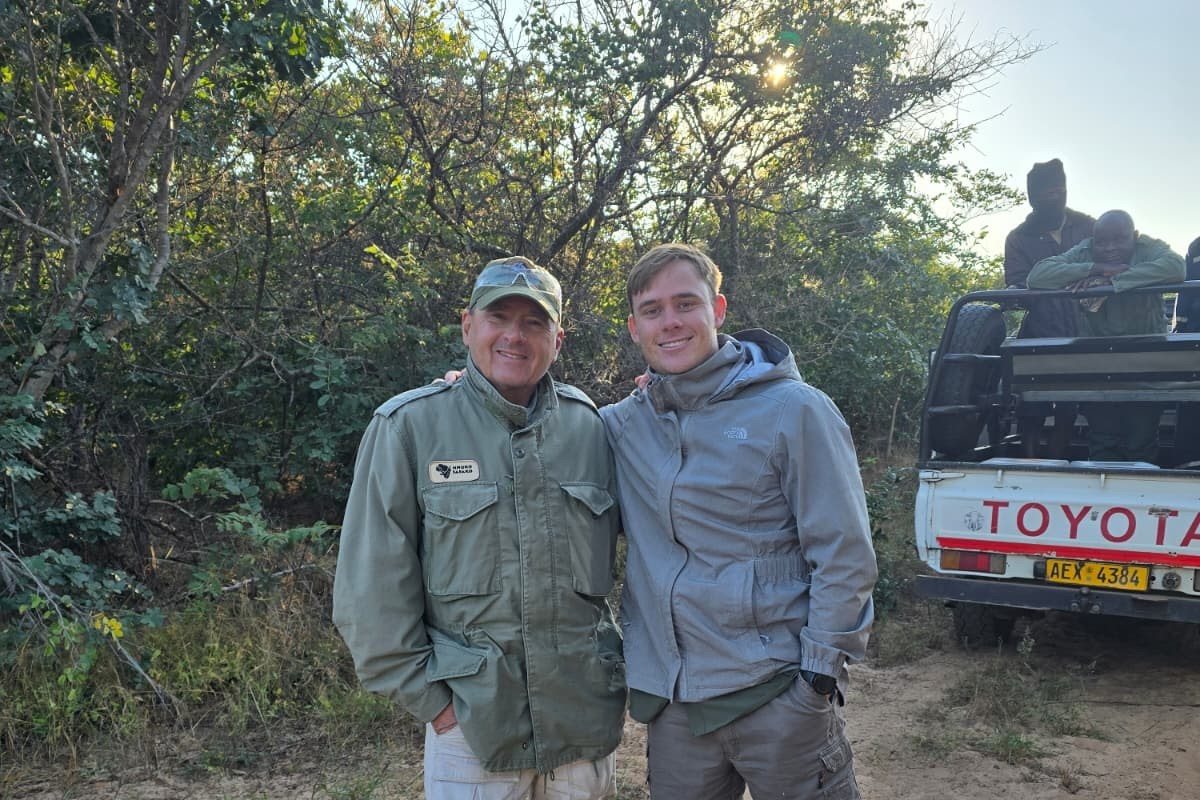 Gordon Stark and Lourens Hills of Nhoro Safaris beside the hunting vehicle with the tracking team, Zimbabwe