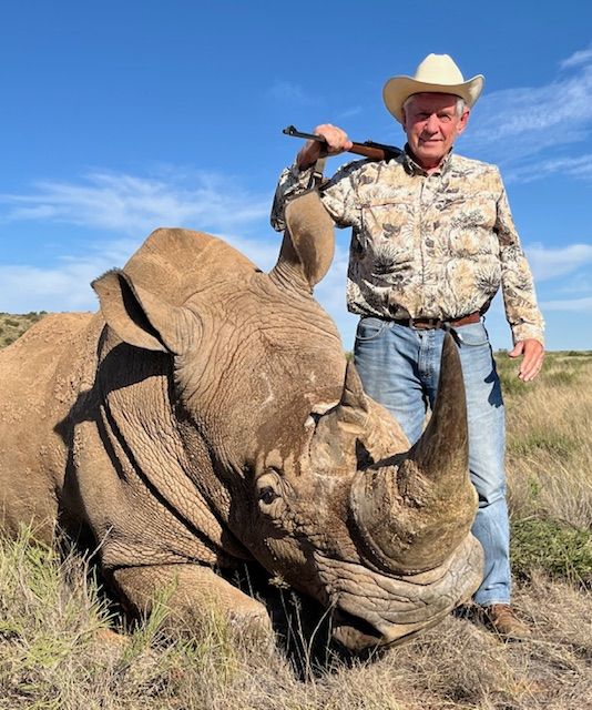 Anthony Denison with the sedated white rhino bull he darted to complete his Big Five, South Africa, with Nhoro Safaris