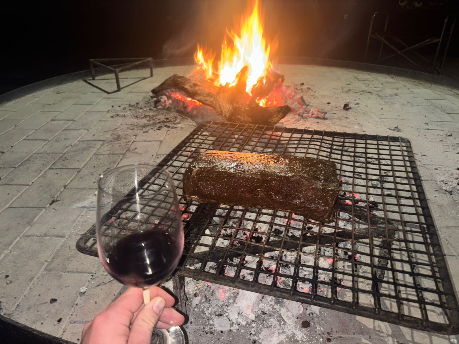 Evening braai over coals at a Nhoro Safaris hunting camp in Zimbabwe