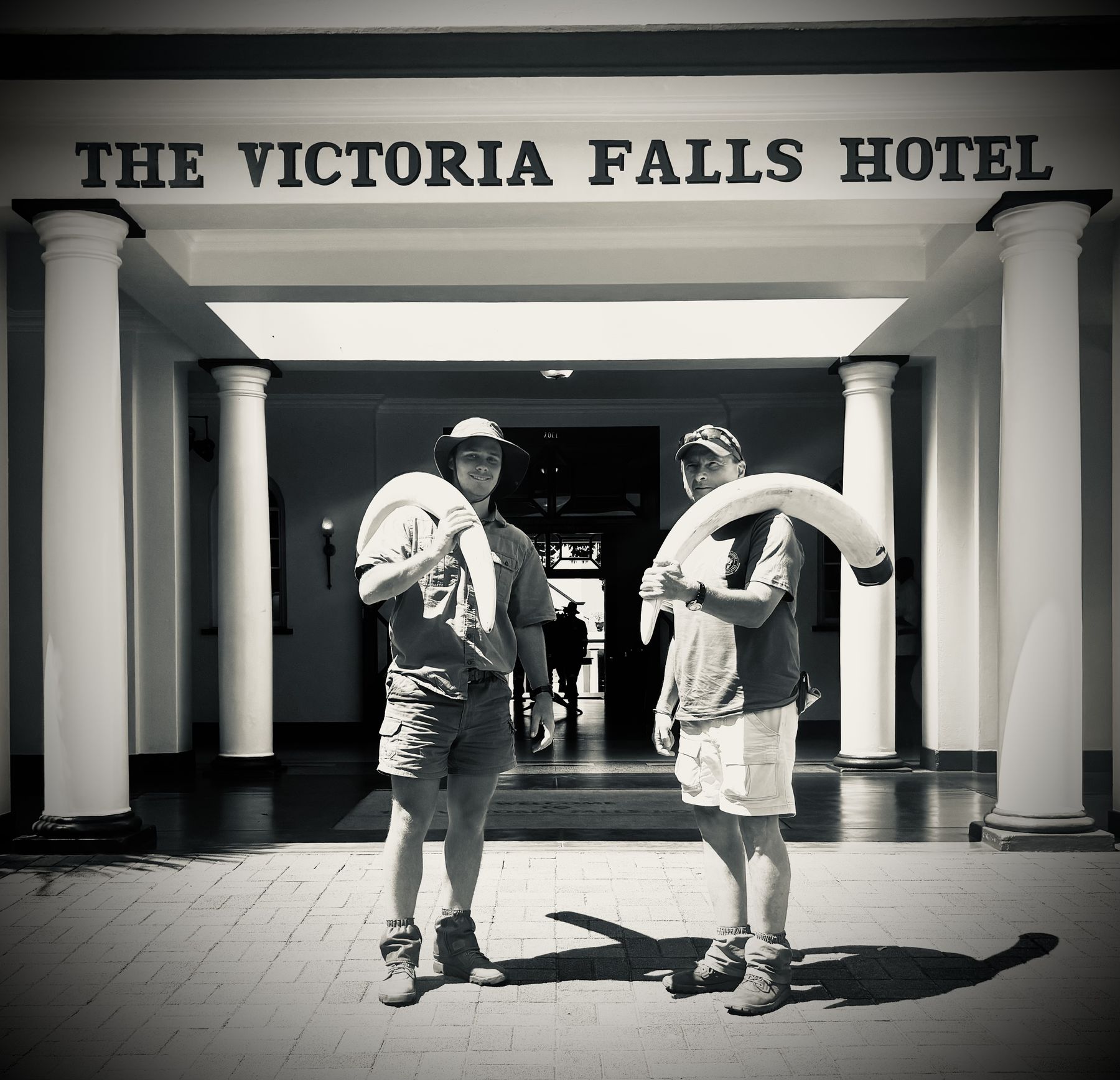Lourens Hills carrying an elephant tusk through the Victoria Falls Hotel, Zimbabwe