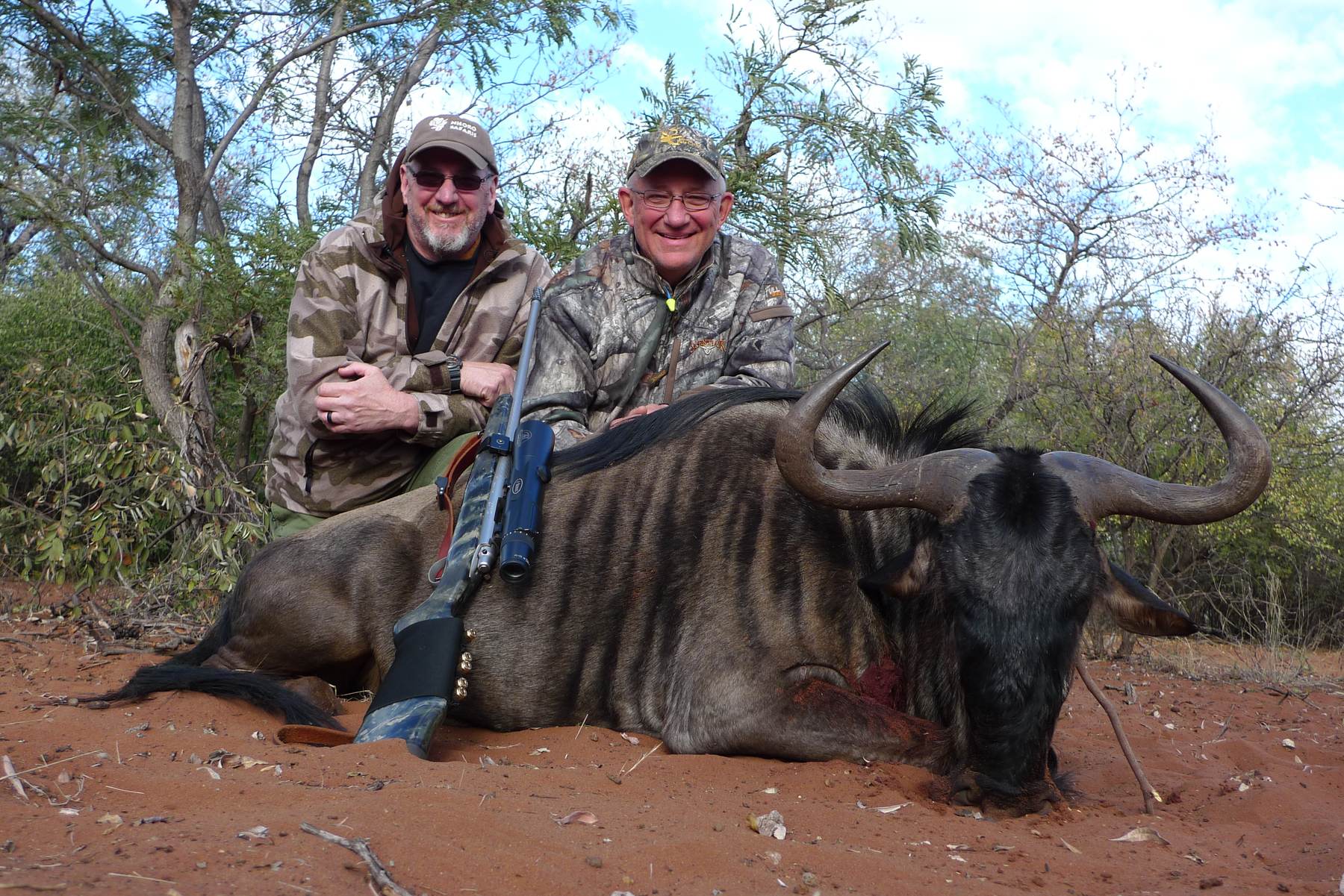 Two hunting clients with a blue wildebeest bull taken in Limpopo, South Africa