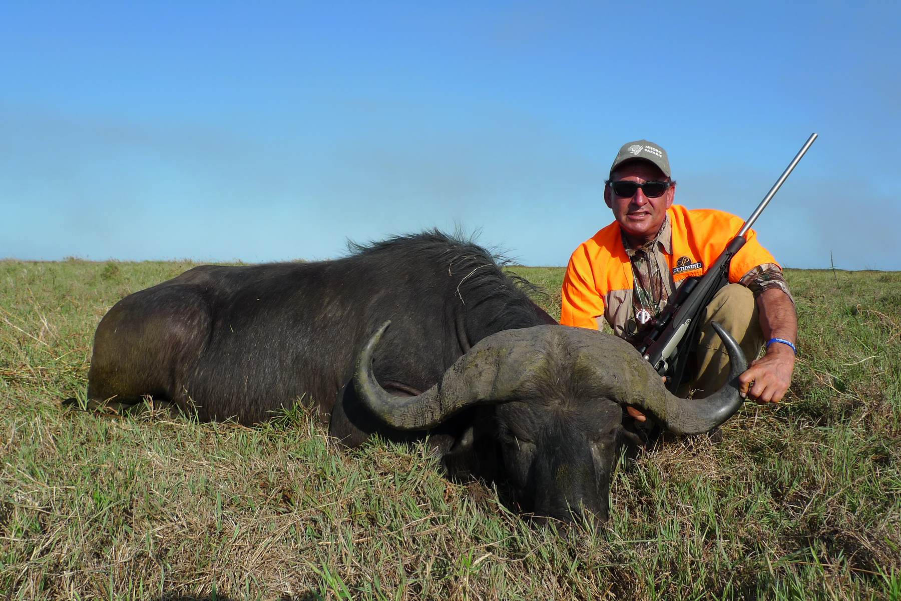 Hunting client with a Cape buffalo bull taken on the Zambezi Delta floodplain, Mozambique