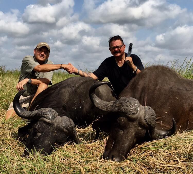 Two hunting clients with two Cape buffalo bulls taken in the Zambezi Delta, Mozambique