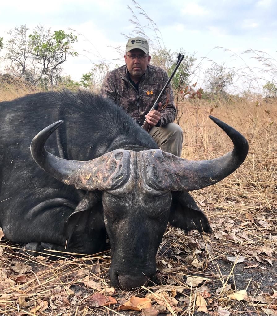 Hunter with a heavy-bossed Cape buffalo bull taken in Zimbabwe