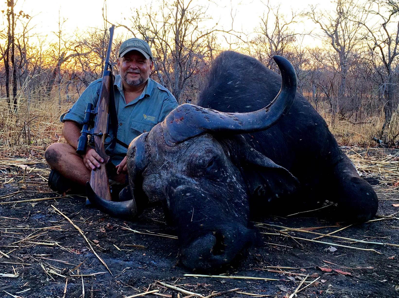 Hunter with a Cape buffalo bull taken at last light in Zimbabwe