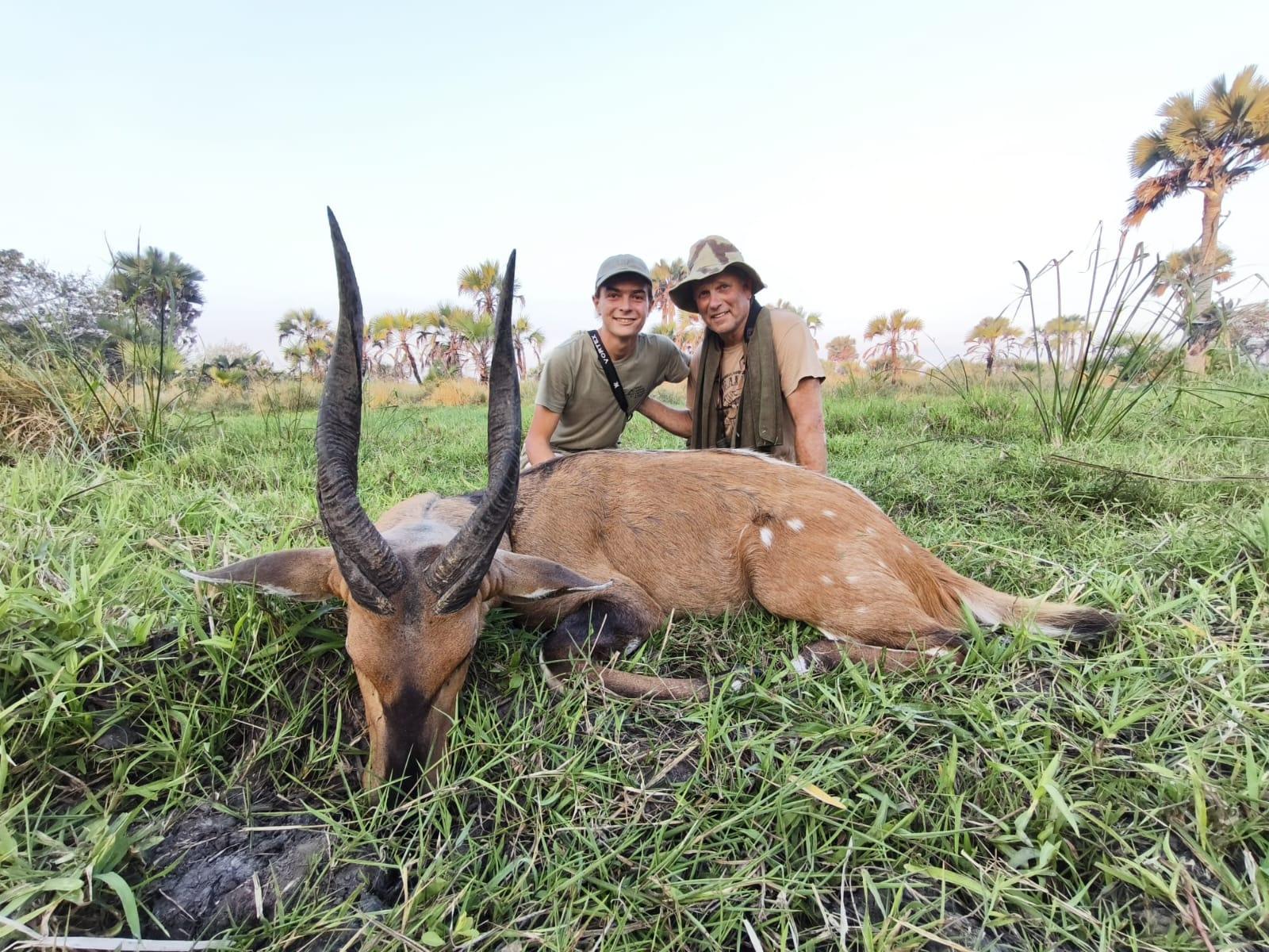 Two hunting clients with a bushbuck ram taken in the Zambezi Delta, Mozambique