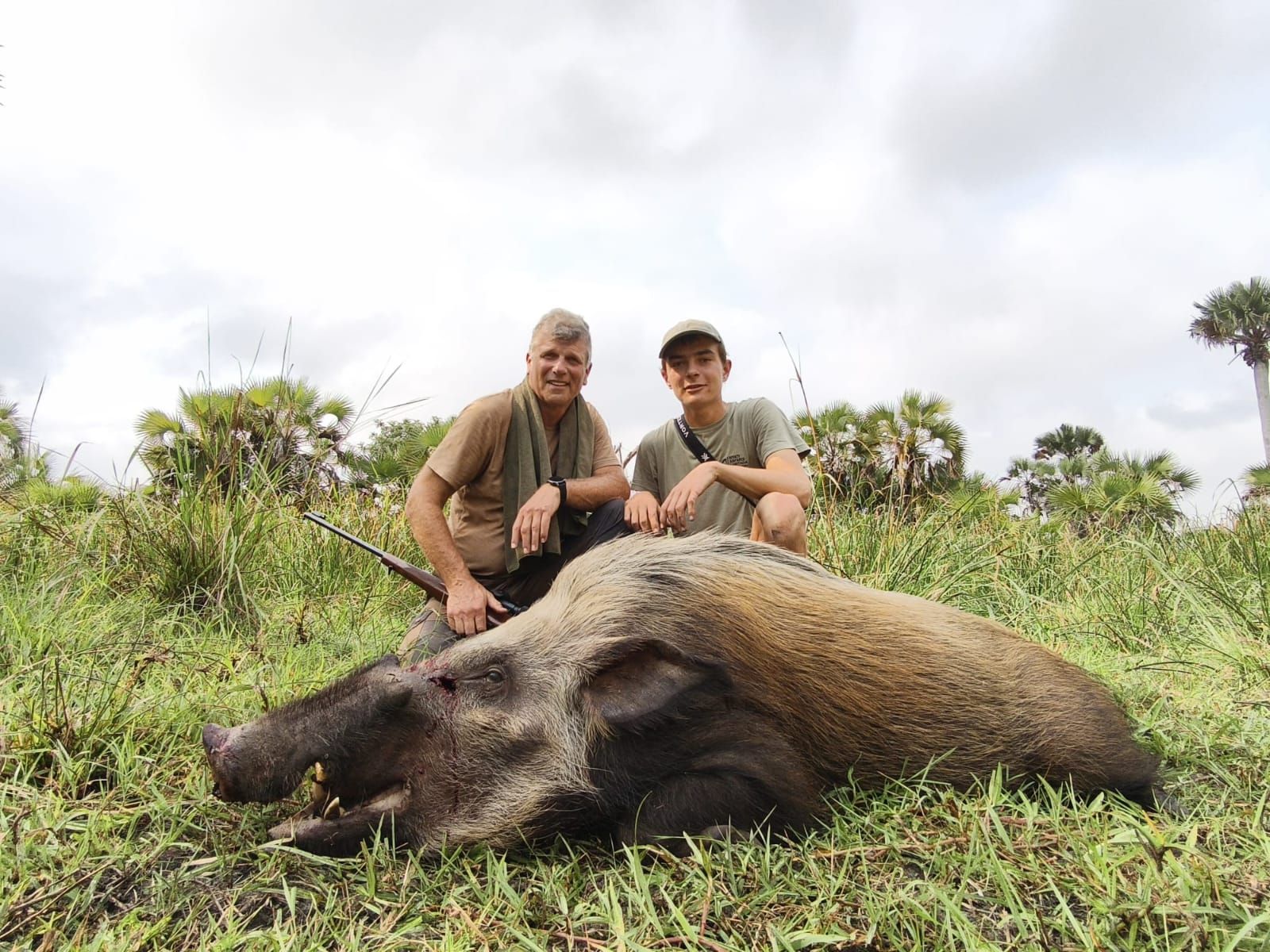 Two hunters with a bushpig boar taken in Zimbabwe