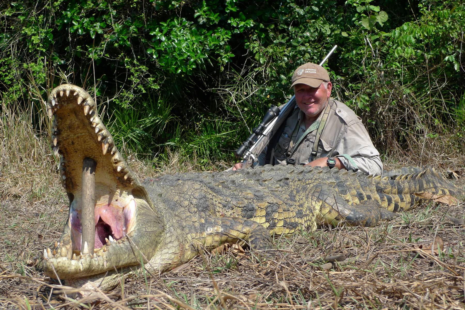 Hunter with a large Nile crocodile taken on the Kariba shoreline, Zimbabwe