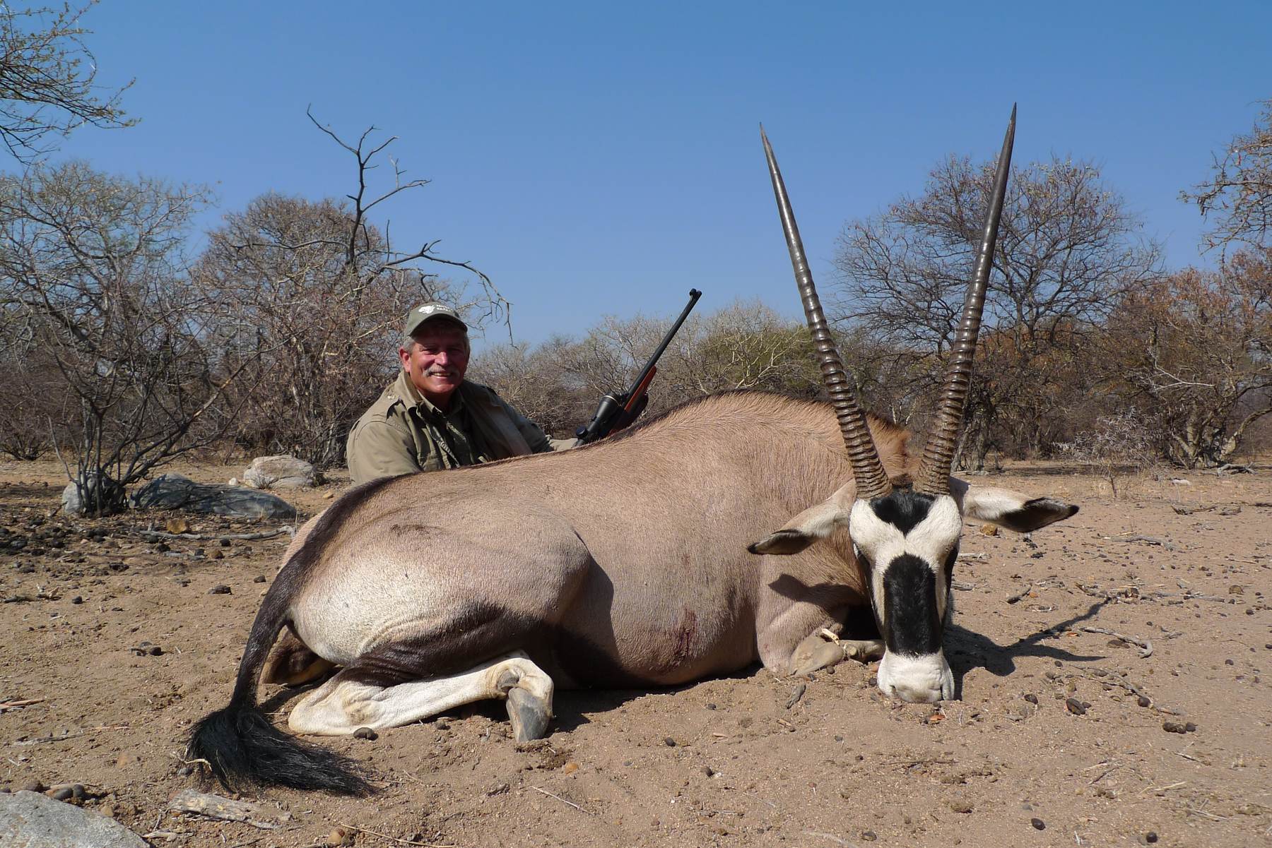 Hunting client with a gemsbok taken in open bush, Limpopo, South Africa