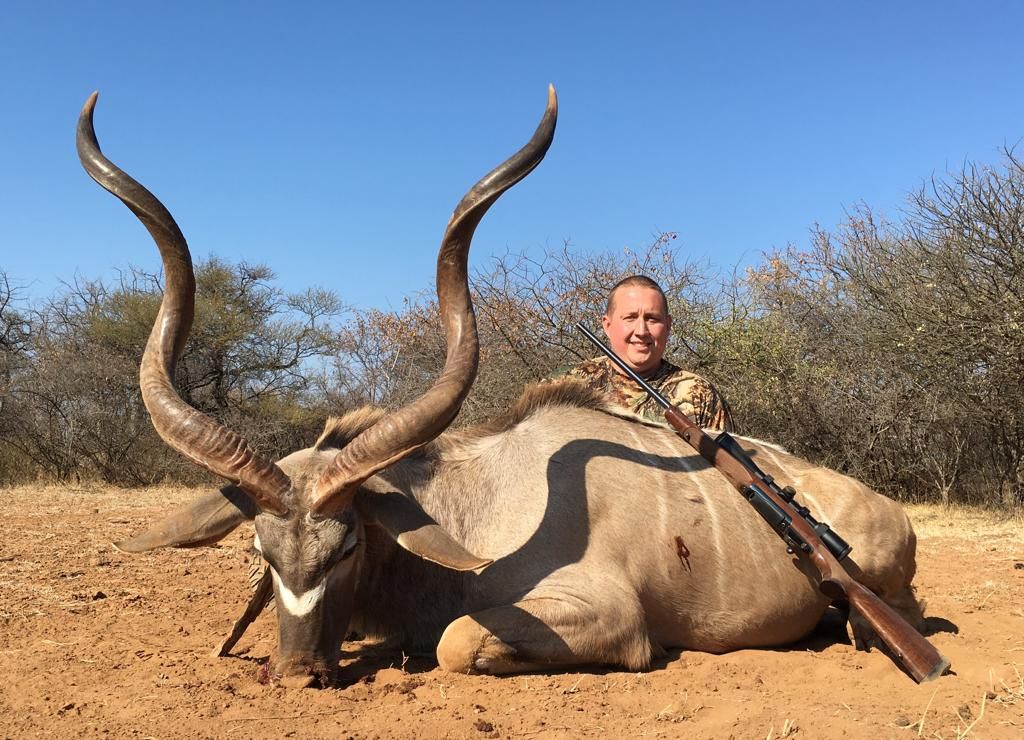 Hunting client with a kudu bull with ivory horn tips, Limpopo, South Africa