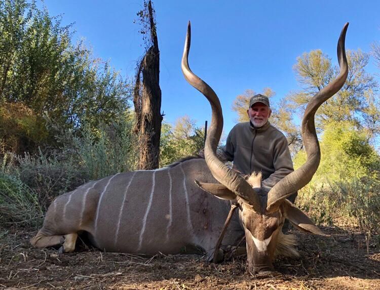 Hunting client with a kudu bull taken in riverine bush, Limpopo, South Africa