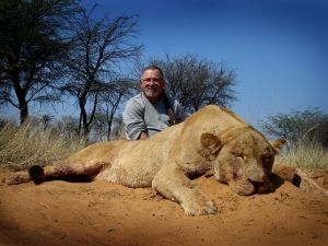 Hunting client with a lioness taken on open sand