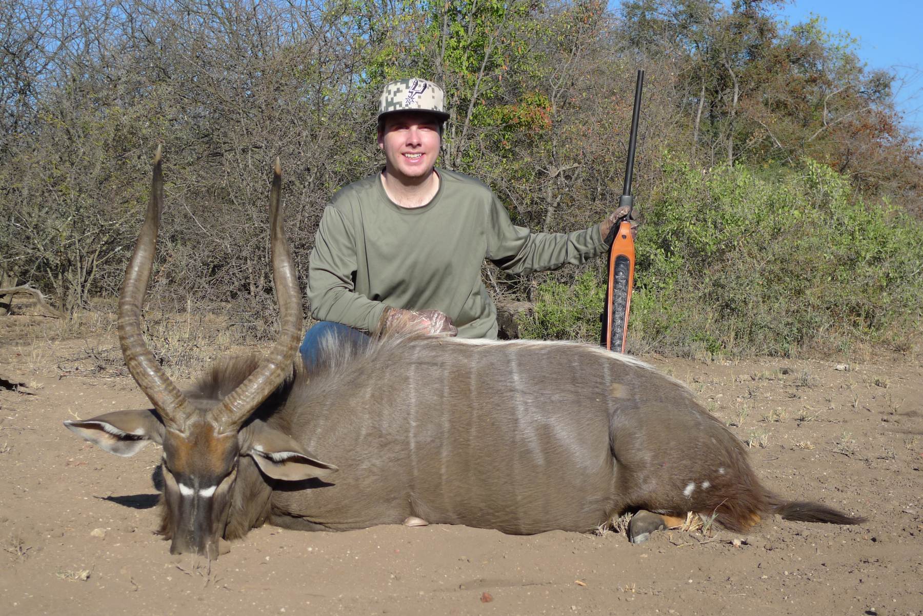 Hunter with a nyala bull with white-tipped horns, Limpopo, South Africa