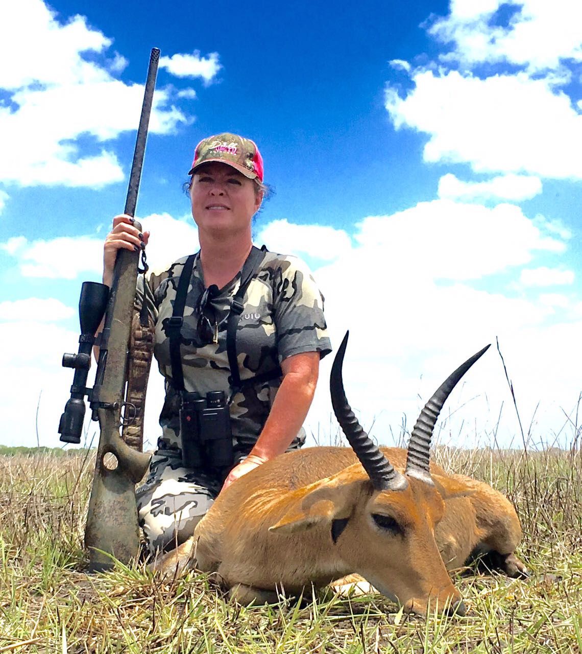 Hunting client with a reedbuck ram taken on vlei grassland, Zimbabwe