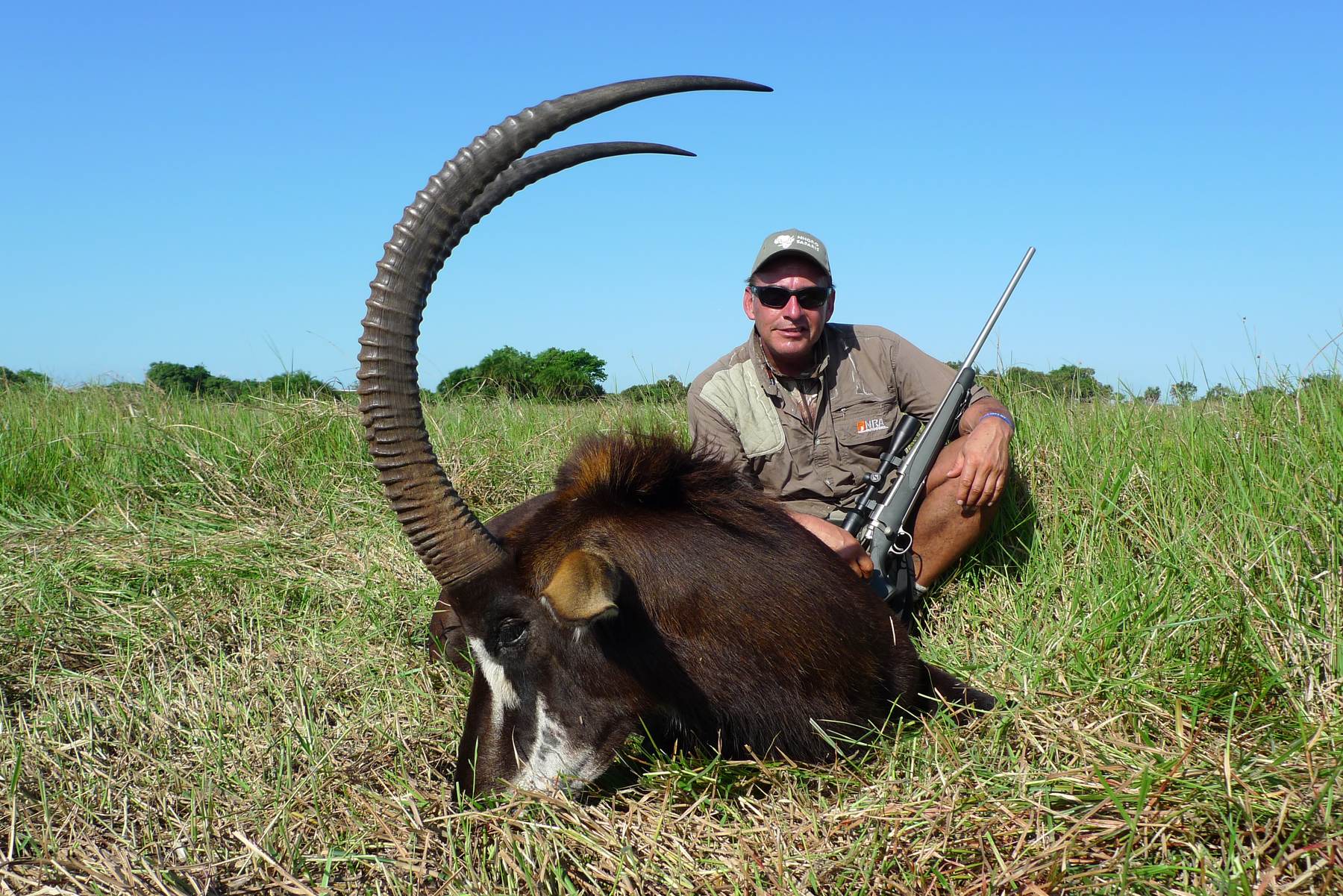 Hunting client with a sable bull taken in Delta grass, Mozambique