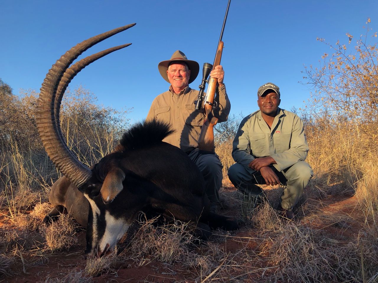 Hunting client and tracker with a sable bull taken in Zimbabwe