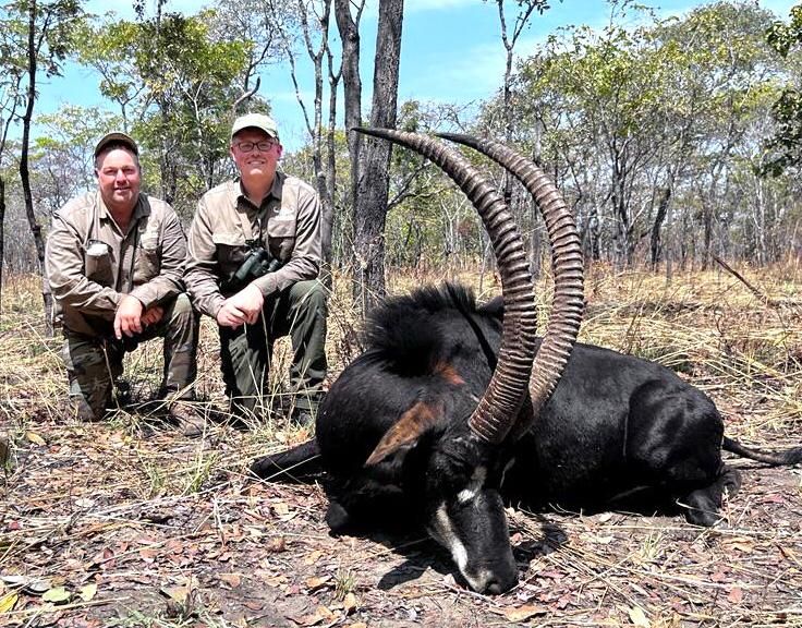 Two hunters with a sable bull taken in Zimbabwe