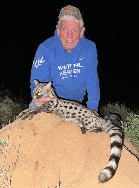 Hunting client with a genet taken on a night hunt in Limpopo, South Africa