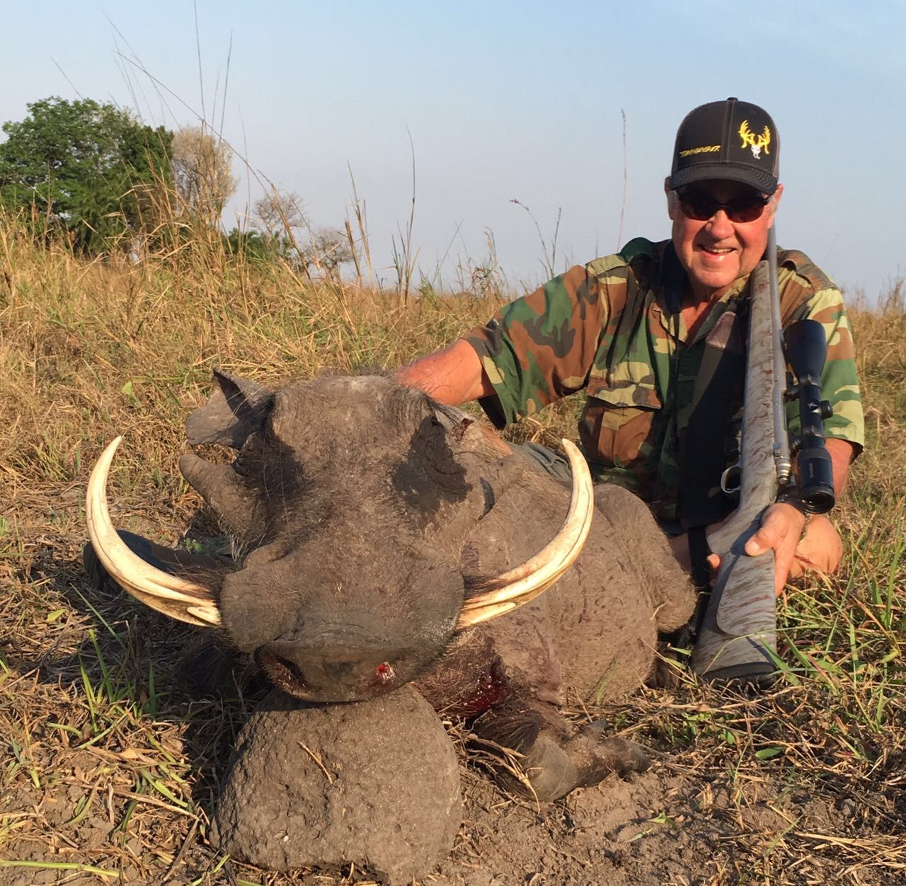 Hunting client with a long-tusked warthog boar taken in Limpopo, South Africa
