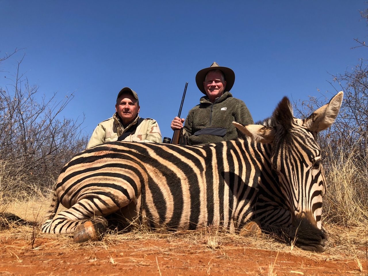 Two hunting clients with a Burchell's zebra stallion taken in Limpopo, South Africa