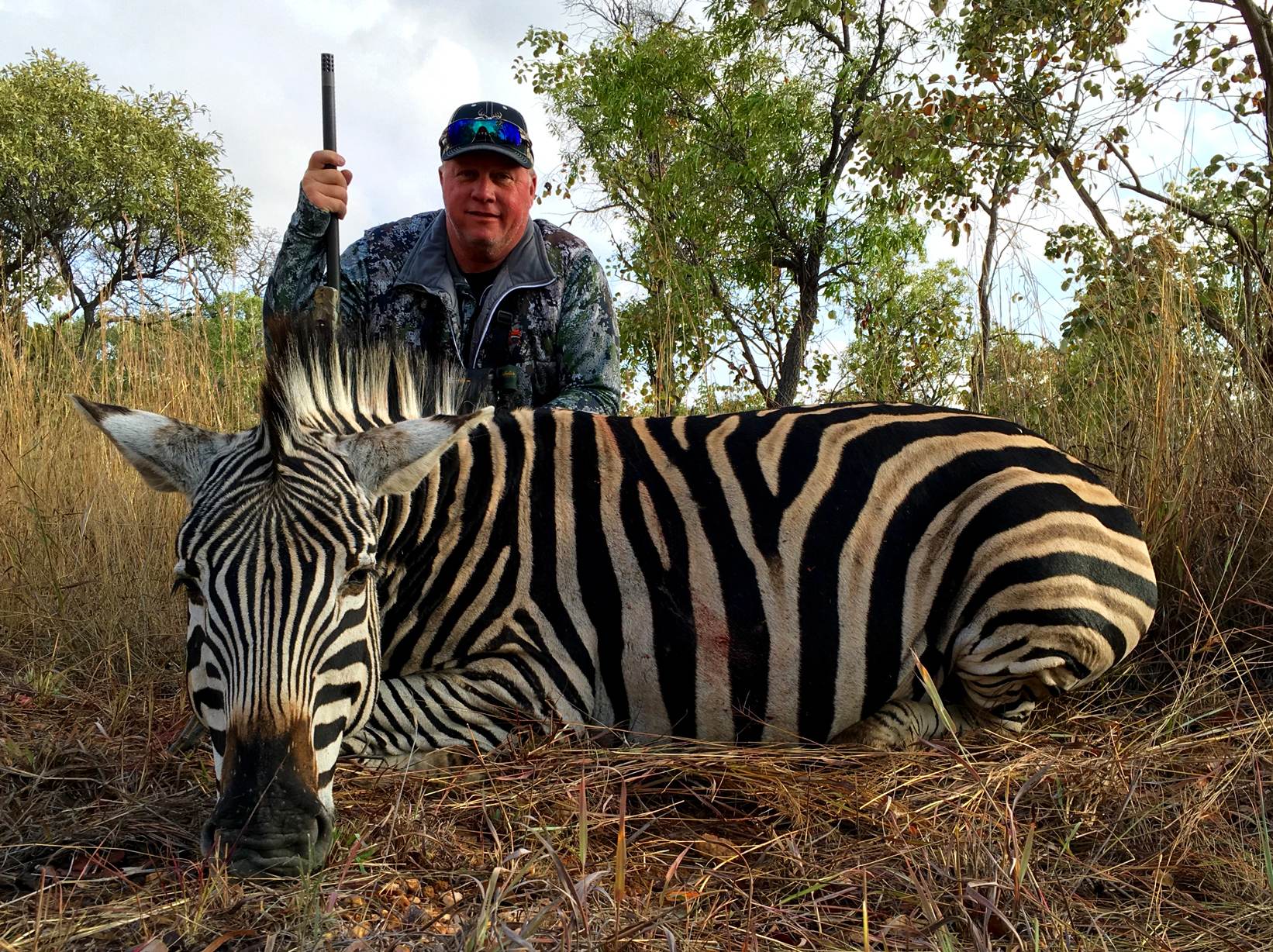 Hunter with a Burchell's zebra taken in Limpopo, South Africa
