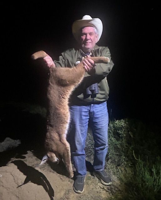 Hunting client holding a caracal taken on a night hunt in Limpopo, South Africa