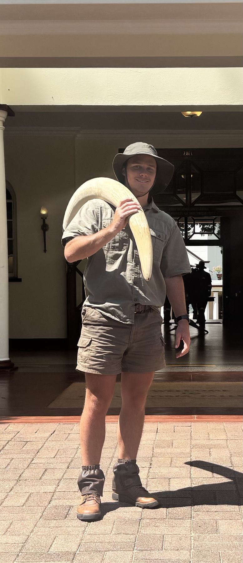 Lourens Hills, professional hunter with Nhoro Safaris, with an elephant tusk over his shoulder